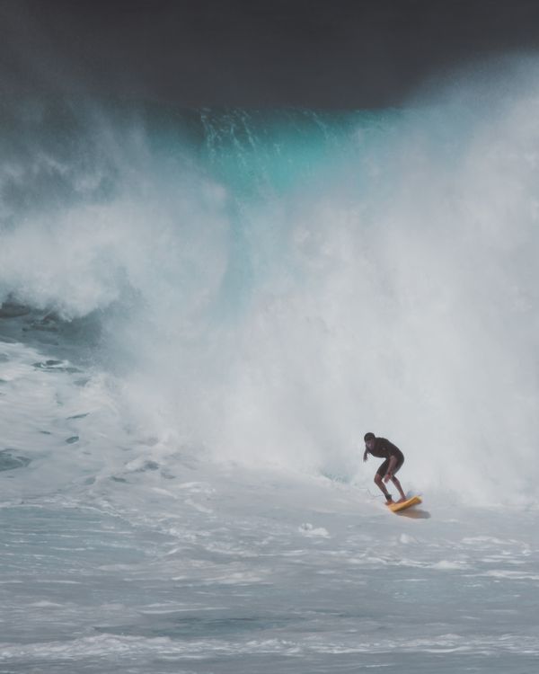 A surfer riding a clean wave in the afternoon light