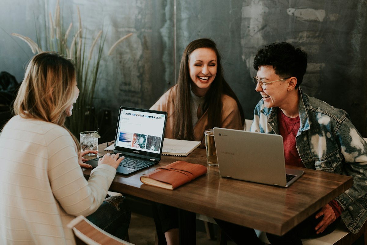 A remote worker on a laptop in a bright coworking space