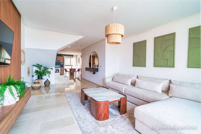 Living room of the BigBlue Bay Duplex with a corner sofa and the kitchenette beyond