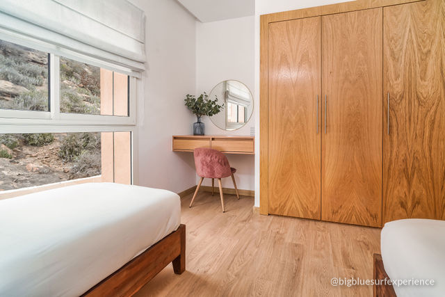 Desk, mirror and full-height wardrobe in the twin bedroom of the BigBlue Bay Duplex