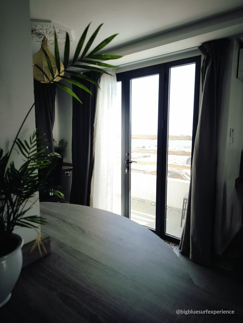 Desk facing the terrace door with ocean light, Taghazout coworking