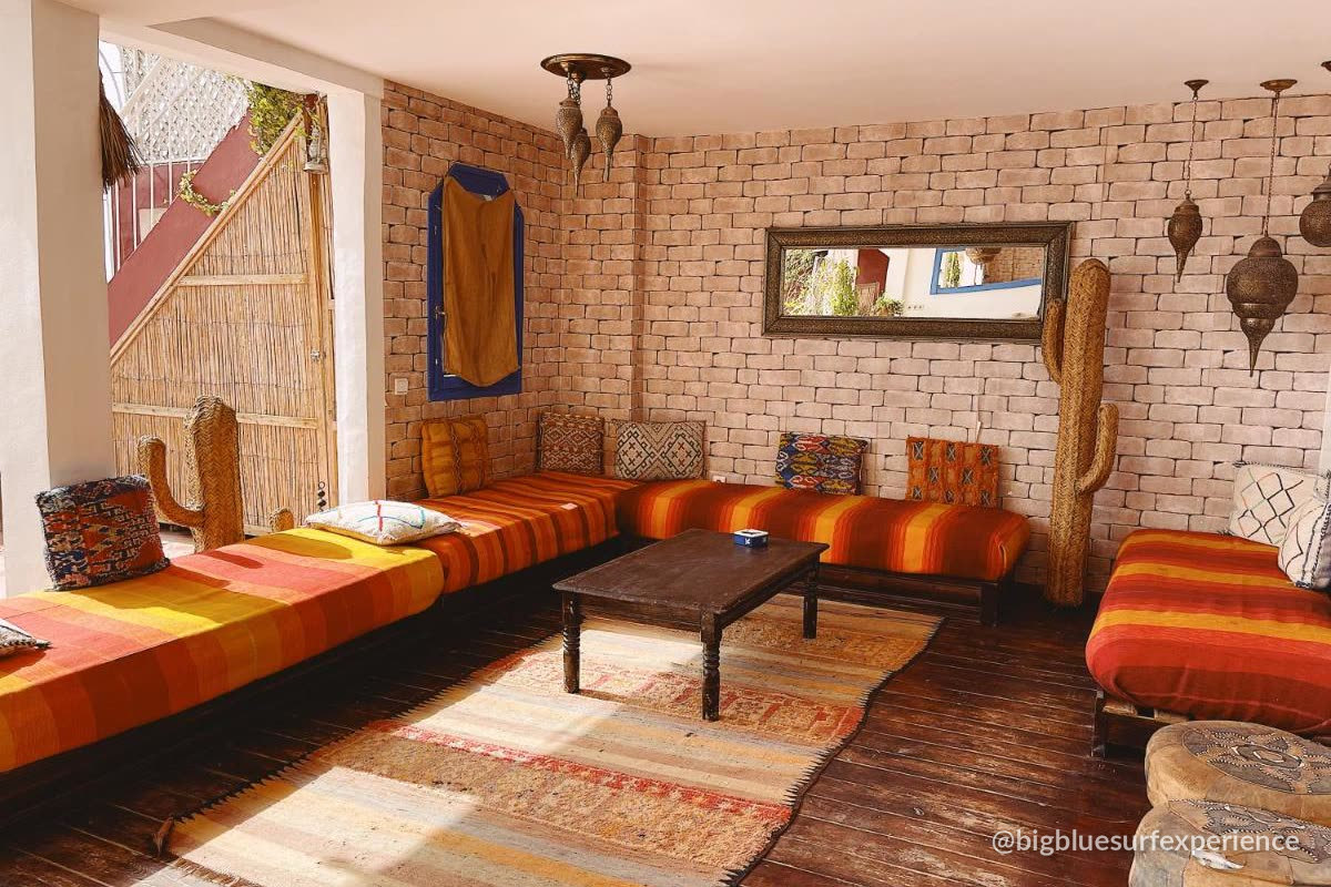 Rooftop lounge with brick wall, lanterns and low seating