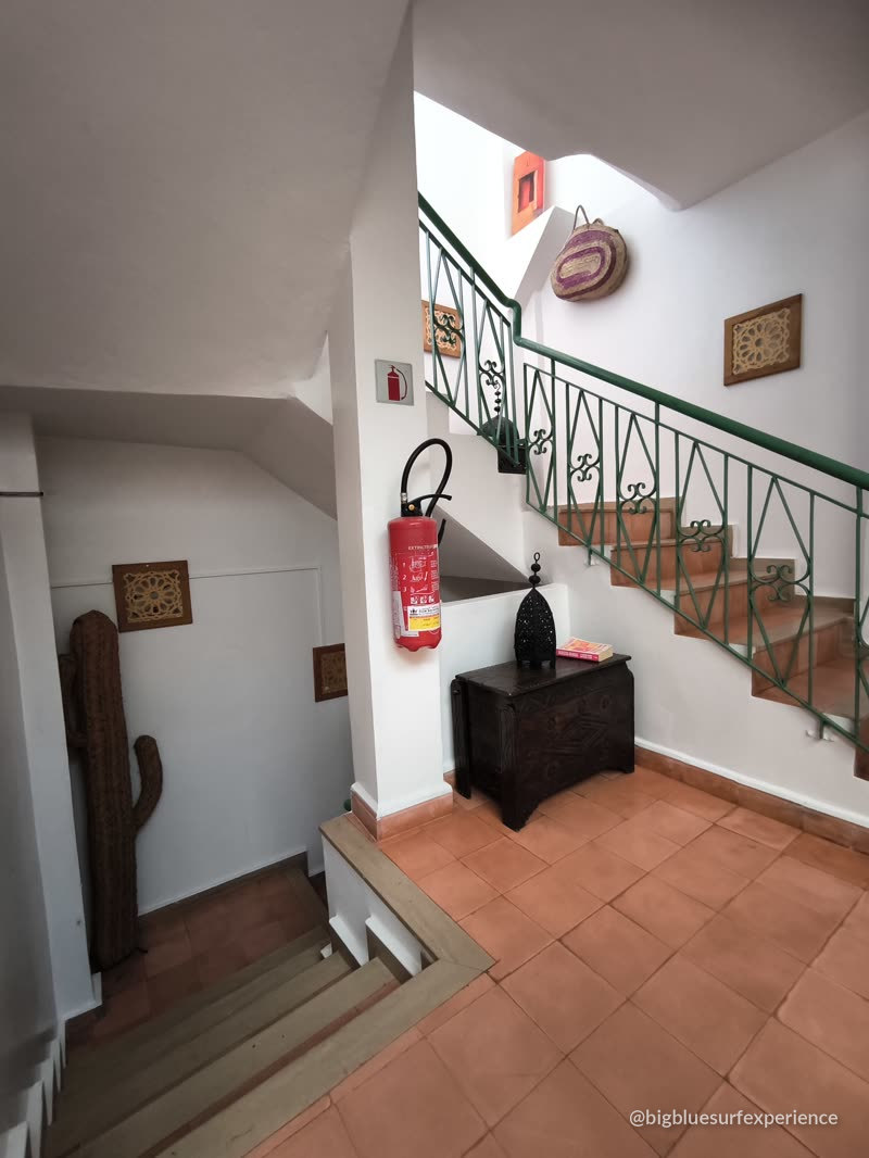Staircase with green railing and Moroccan wall pieces