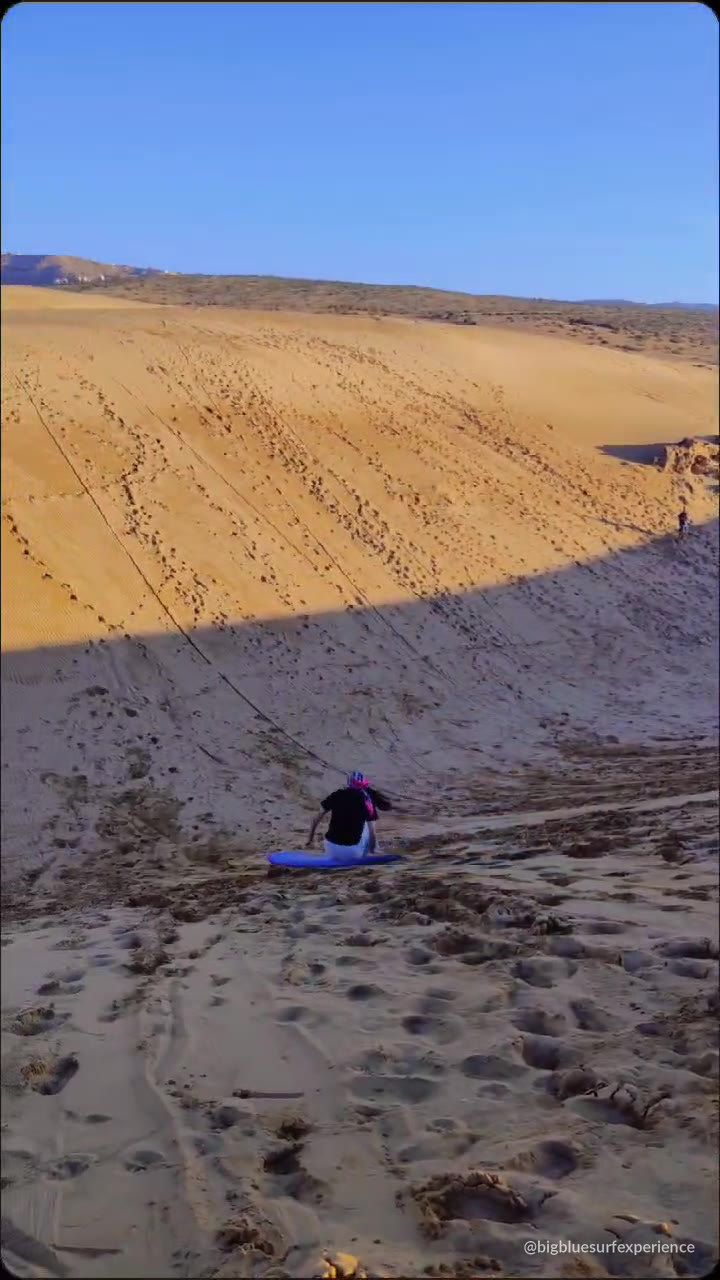 Group sandboarding on the Timlaline dunes near Agadir