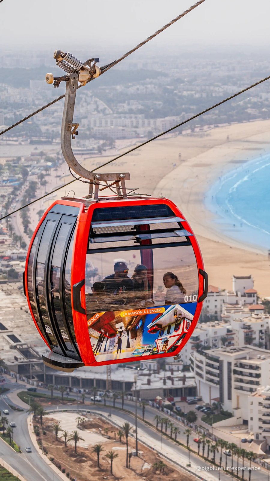 Red cable car gondola above Agadir bay on the way up to the Kasbah viewpoint